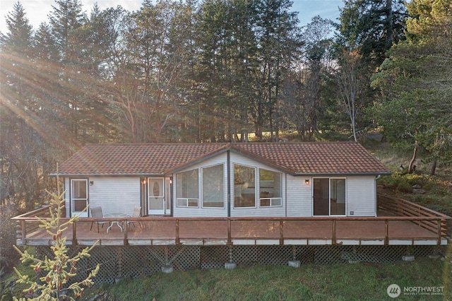 view of front of property with a tile roof and a wooden deck