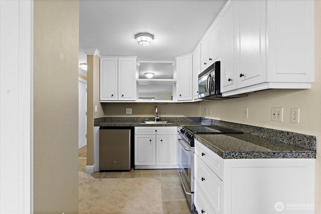 kitchen with open shelves, stainless steel appliances, white cabinetry, a sink, and dark stone counters