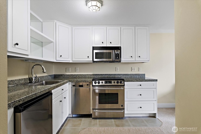 kitchen featuring open shelves, appliances with stainless steel finishes, ornamental molding, white cabinets, and a sink