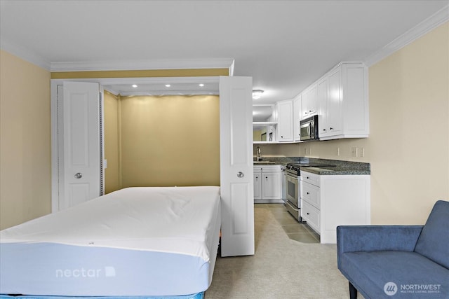 bedroom featuring light colored carpet, crown molding, and a sink