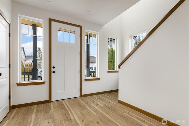 entryway featuring light wood-style flooring and baseboards