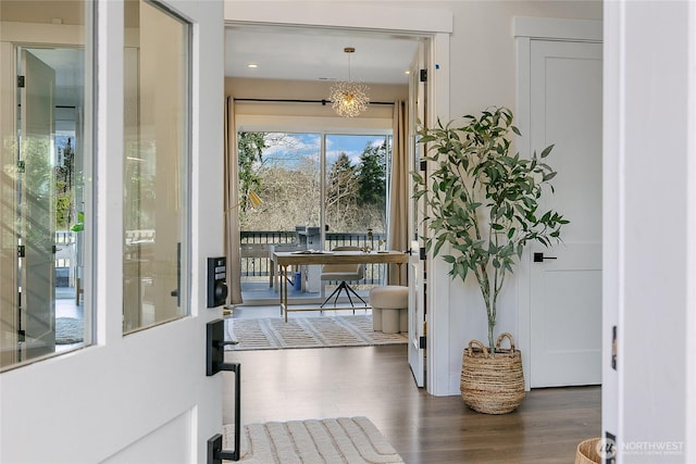 entryway with a chandelier and dark wood-style flooring