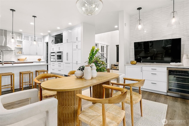 dining room with wine cooler, dark wood-style flooring, and recessed lighting