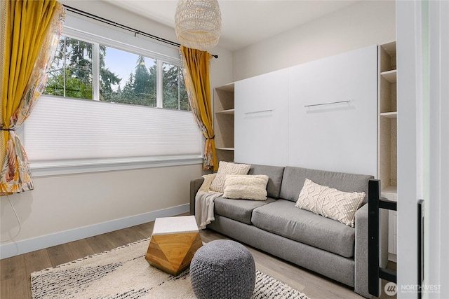 living room featuring light wood-type flooring and baseboards