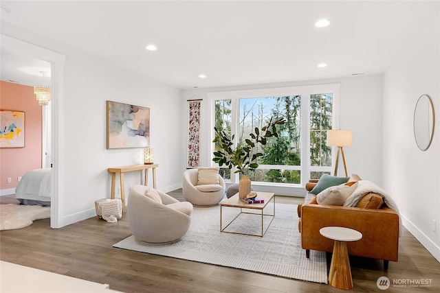 living area with baseboards, dark wood finished floors, and recessed lighting