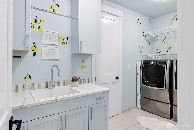 clothes washing area featuring separate washer and dryer, a sink, and cabinet space