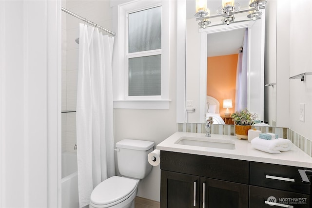 ensuite bathroom with toilet, ensuite bath, shower / bath combination with curtain, and vanity