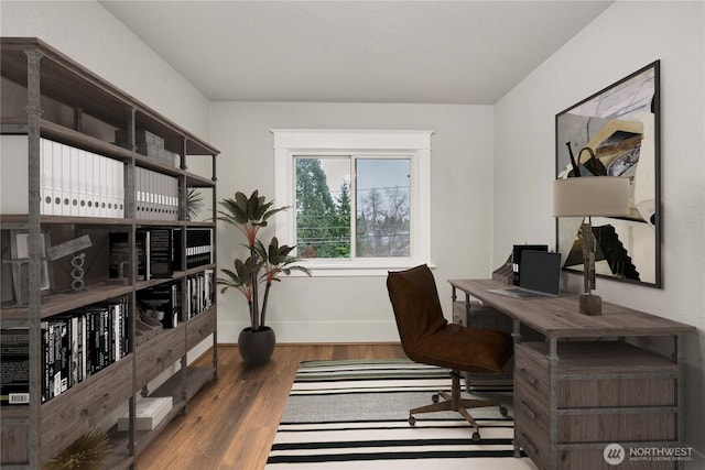 office area featuring dark wood-type flooring and baseboards