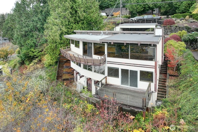 back of house featuring stairs