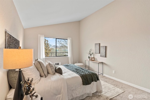 bedroom with lofted ceiling, carpet floors, and baseboards