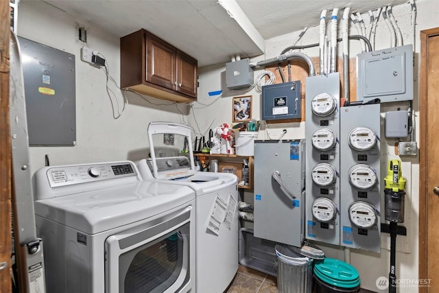 clothes washing area with cabinet space, electric panel, and independent washer and dryer