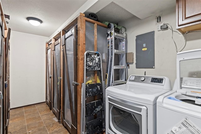 laundry area featuring a textured ceiling, washing machine and dryer, and cabinet space