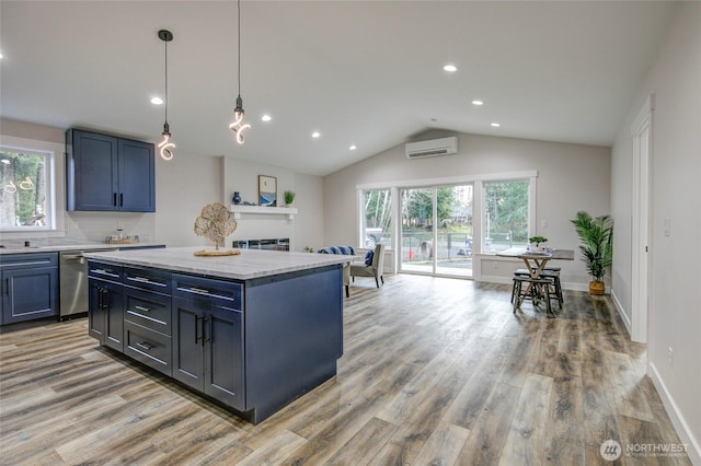 kitchen featuring dishwasher, light wood-style floors, a wall mounted AC, and a healthy amount of sunlight