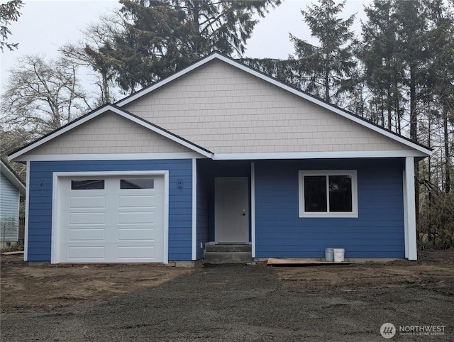 ranch-style home with a garage and driveway