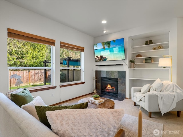 carpeted living room with built in shelves, a fireplace, and recessed lighting