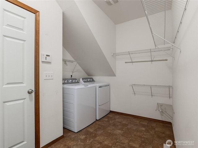 laundry area with laundry area, visible vents, baseboards, and separate washer and dryer