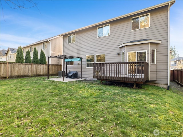 rear view of house featuring a deck, a fenced backyard, central AC, a lawn, and a patio area