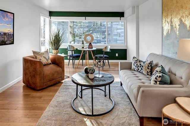 living room featuring baseboards and wood finished floors