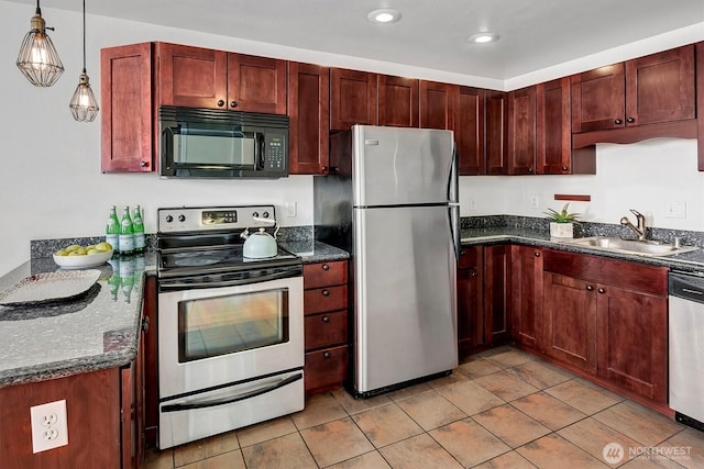 kitchen with a sink, hanging light fixtures, dark brown cabinets, and stainless steel appliances