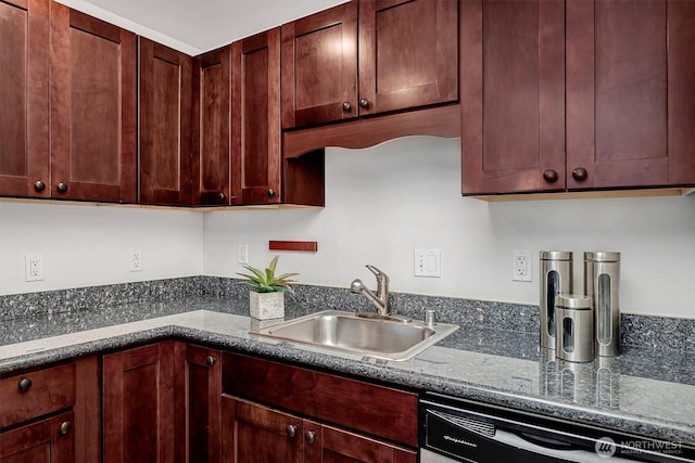 kitchen featuring a sink, dishwashing machine, reddish brown cabinets, and dark stone countertops