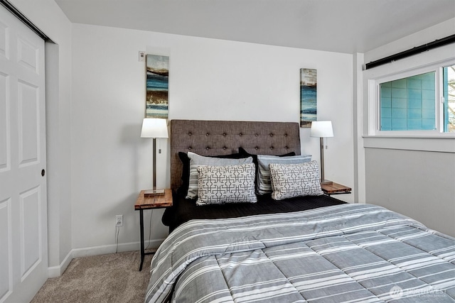 bedroom featuring baseboards and carpet floors