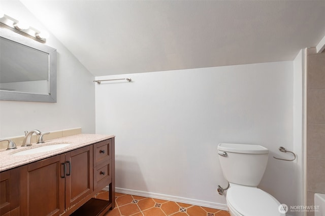 full bath featuring baseboards, toilet, a bathtub, vaulted ceiling, and vanity