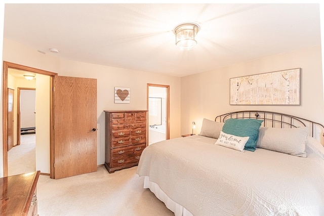 bedroom with light colored carpet and ensuite bathroom