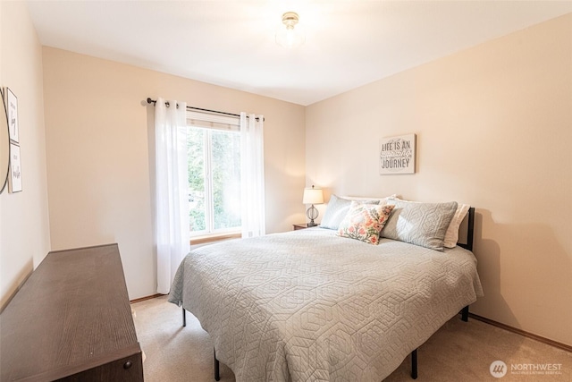 carpeted bedroom featuring baseboards