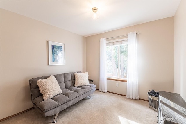 living area with light colored carpet and baseboards