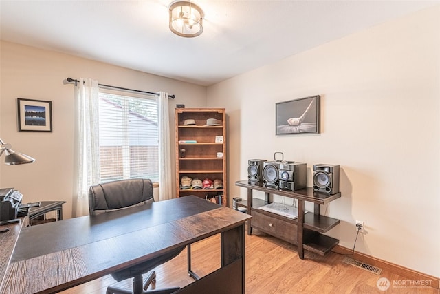 office featuring visible vents, baseboards, and light wood-style floors