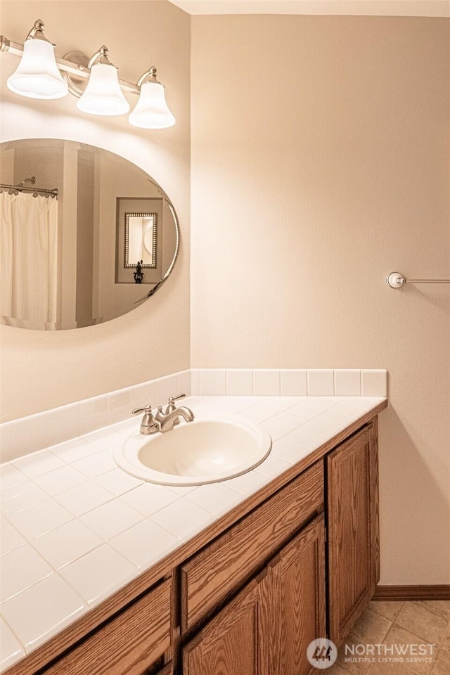 bathroom with tile patterned floors and vanity