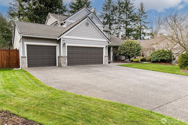 craftsman-style home with aphalt driveway, an attached garage, a front lawn, and fence