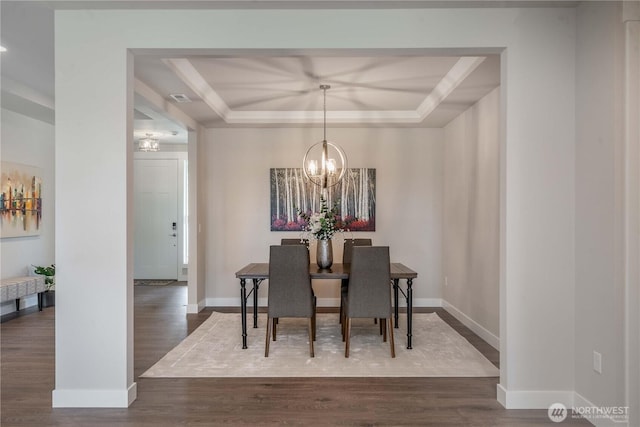 15814 Boise Ln SE, Yelm, WA 98597 - dining area with baseboards, a tray ceiling, a chandelier, and dark wood-type flooring