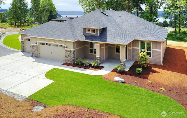 view of front of house featuring a garage, concrete driveway, stone siding, roof with shingles, and board and batten siding