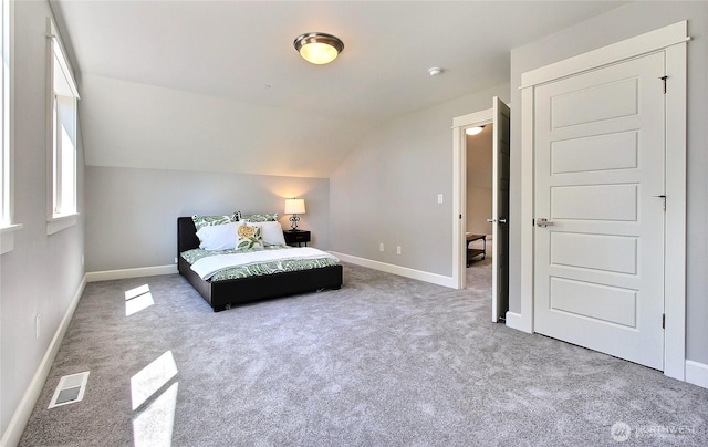 15814 Boise Ln SE, Yelm, WA 98597 - unfurnished bedroom featuring carpet, visible vents, vaulted ceiling, and baseboards