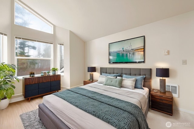 bedroom with baseboards and vaulted ceiling