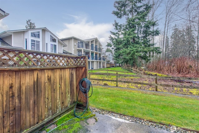 view of yard with fence and a residential view