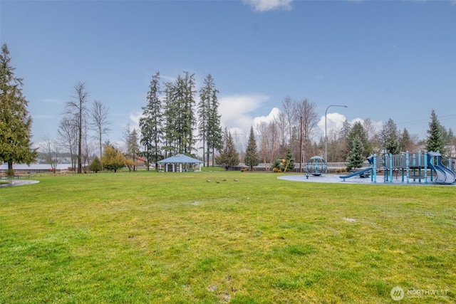 view of yard featuring playground community and a gazebo