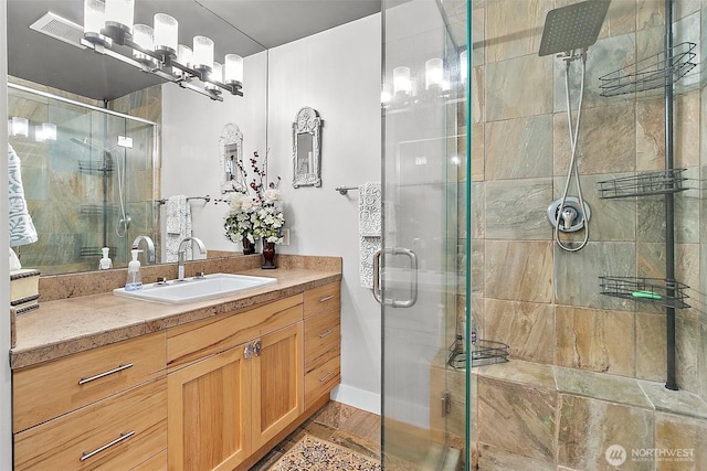 bathroom featuring a stall shower and vanity