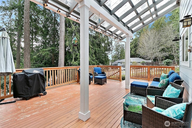 deck with an outdoor living space, a pergola, and area for grilling