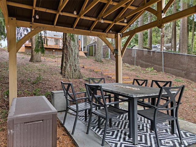 view of patio featuring outdoor dining area and fence