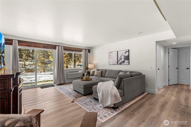 living area with cooling unit, baseboards, wood finished floors, and recessed lighting