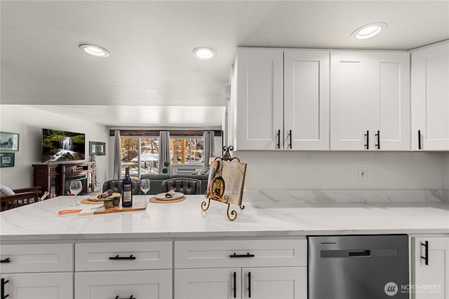 kitchen with light stone countertops, white cabinets, dishwasher, and recessed lighting