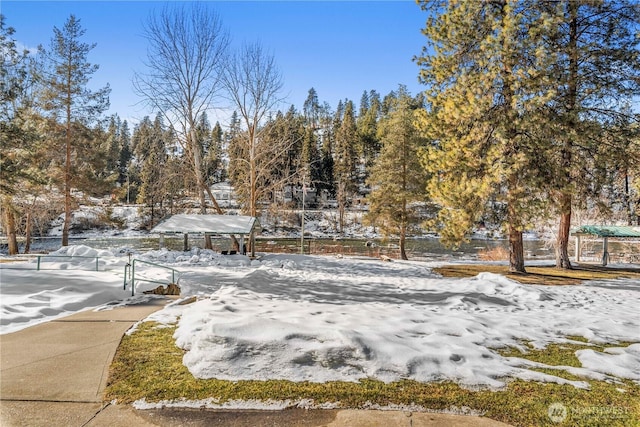 yard covered in snow with fence