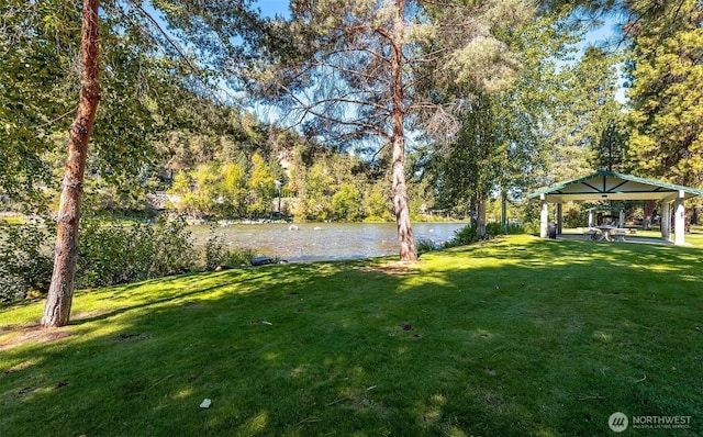 view of yard featuring a gazebo and a water view