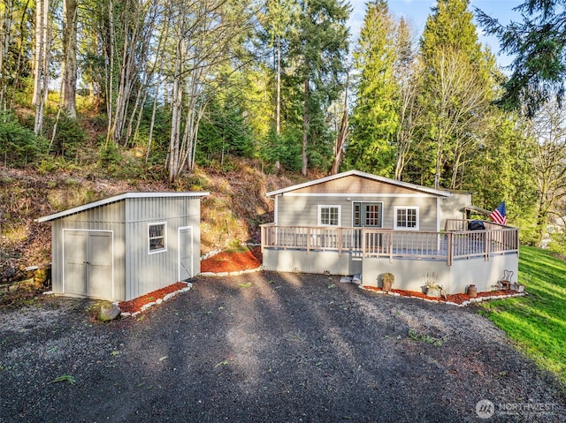 view of front of property featuring an outbuilding and a wooden deck