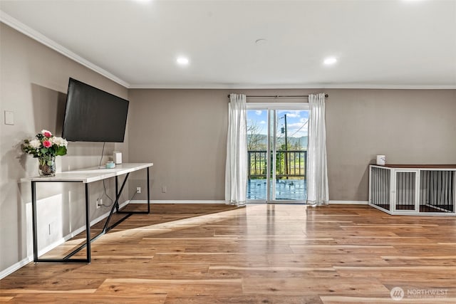 interior space with crown molding, light wood finished floors, recessed lighting, and baseboards