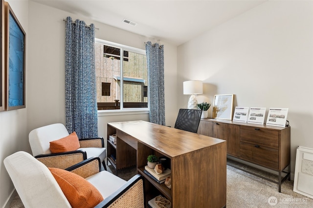 office area with visible vents and light colored carpet