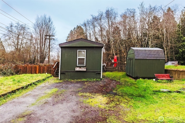 view of shed with fence