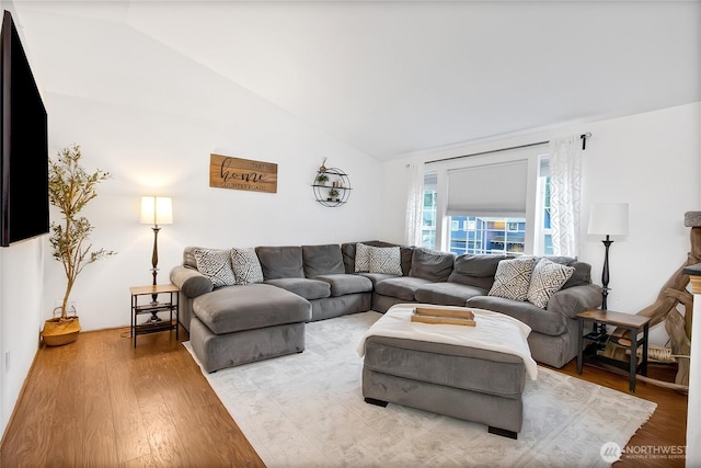 living area featuring vaulted ceiling and light wood-style floors